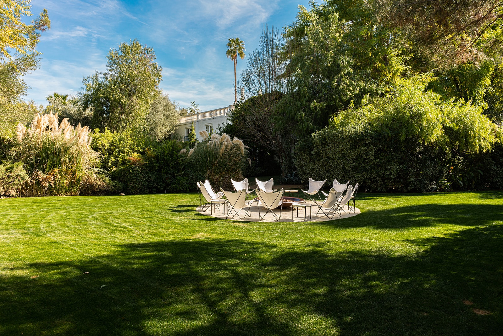 Firepit with circle of chairs on lawn