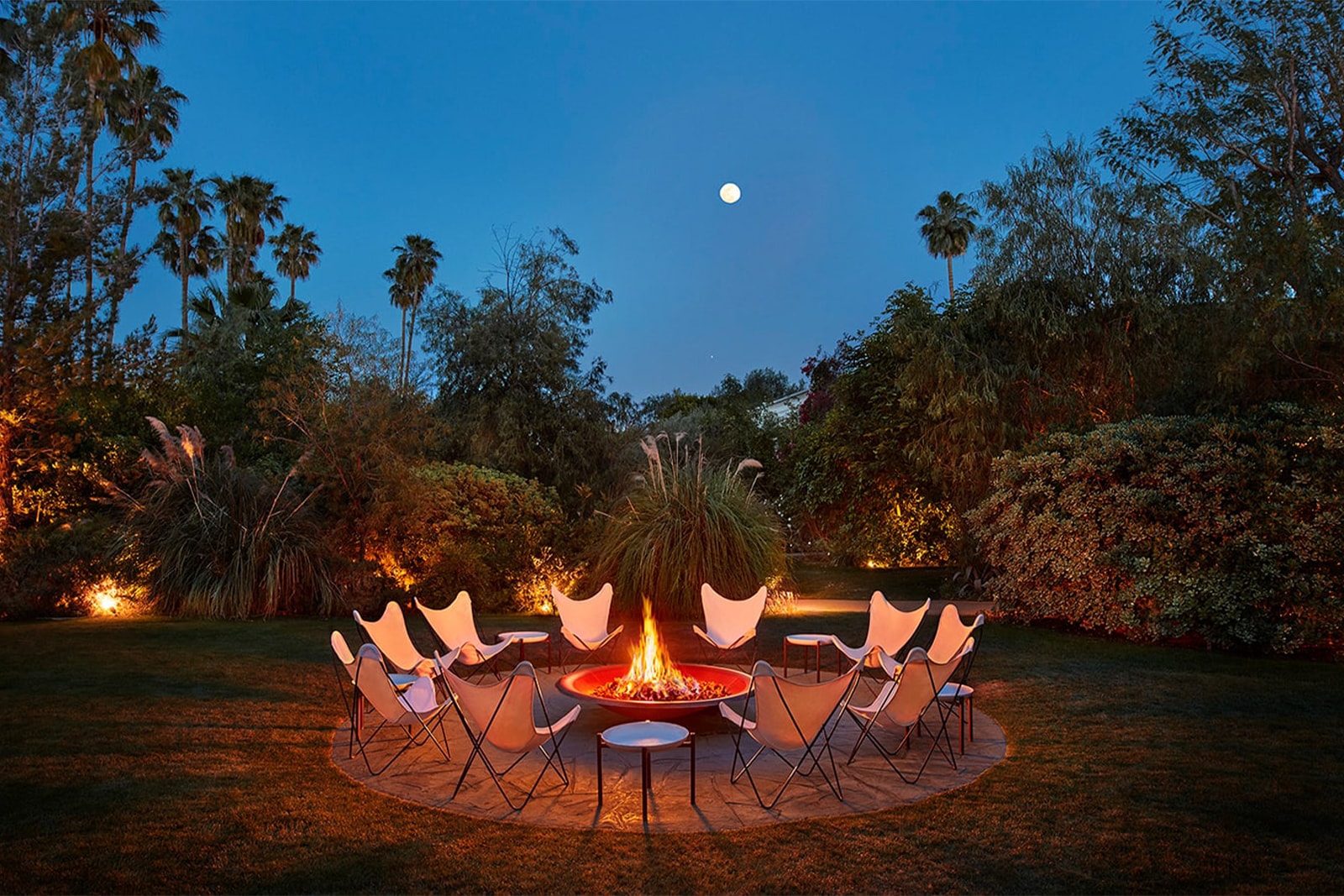 Parker Palm Springs Fire Pit at Night with Circle of Chairs