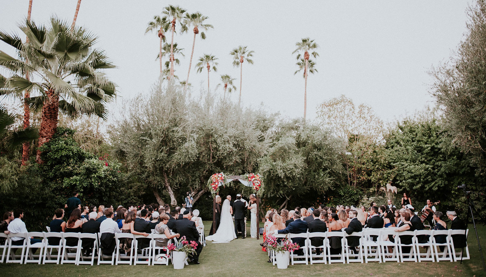 Scenic Palm Springs wedding ceremony featuring lush greenery, elegant decor, and a breathtaking mountain view.